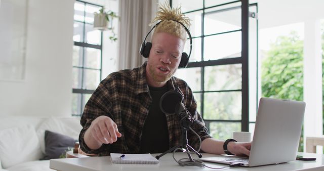 Albino Man Recording Podcast at Home with Laptop and Microphone - Download Free Stock Images Pikwizard.com