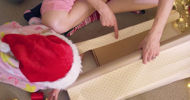 Close-Up of Adult and Child Wrapping Christmas Gift Together - Download Free Stock Images Pikwizard.com