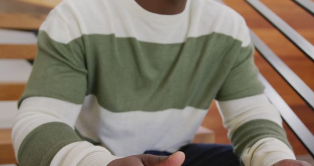 Person Sitting on Wooden Stairs Wearing Green and White Sweater - Download Free Stock Images Pikwizard.com