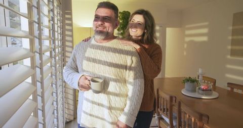 Couple Embracing Sunlight in Cozy Home Atmosphere