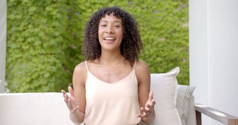 Woman on Video Call Gesturing in Outdoor Relaxed Setting