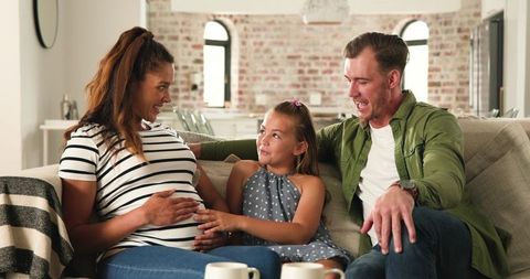 Family Embracing New Beginnings: Expectant Mother and Her Loved Ones