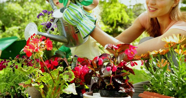 Mother and child watering vibrant flowers in garden using watering can on sunny day. Use for family bonding themes, gardening tips, spring and summer activities, and outdoor lifestyle promotions.