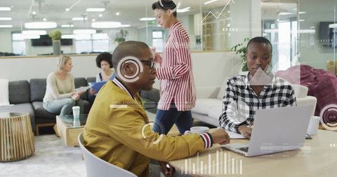 Diverse team analyzing data with digital interface in modern workspace