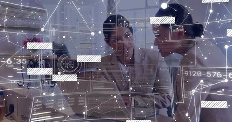 Businesswomen Analyzing Data Overlay in Modern Office Setting