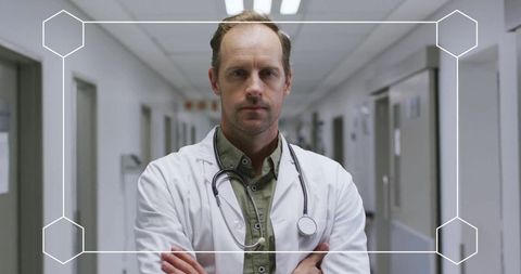 Confident Doctor Standing in Hospital Corridor with Stethoscope