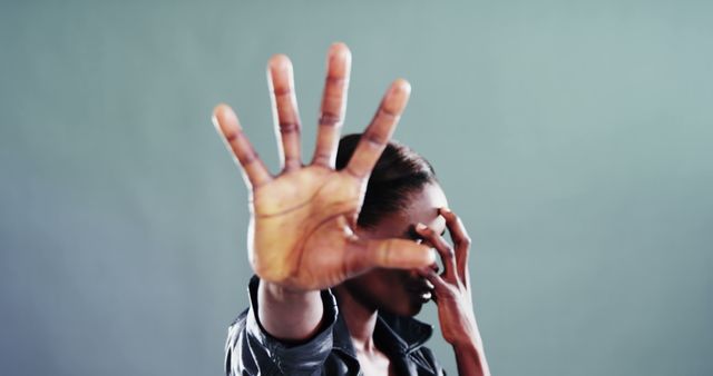 Person Raising Hand to Block Face, Expressing Stop Sign Gesture - Download Free Stock Images Pikwizard.com