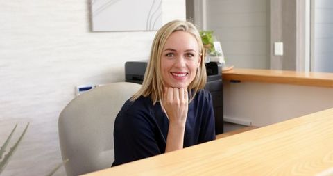 Smiling Receptionist at Modern Medical Clinic Desk - Download Free Stock Images Pikwizard.com