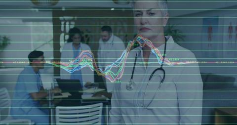 Senior Doctor Evaluating Data in Hospital with Team Collaboration