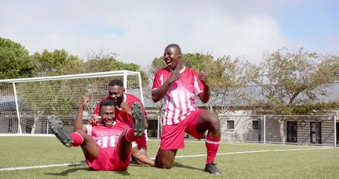 Excited Soccer Team Celebrating Enthusiastic Victory on Field