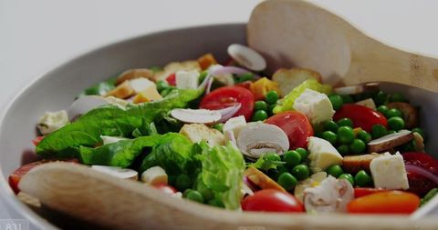Fresh organic salad with vibrant ingredients in ceramic bowl