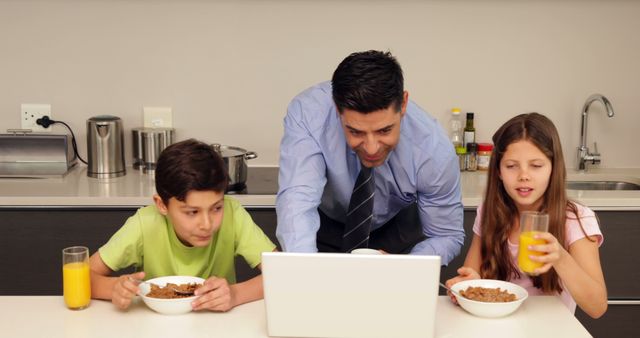 Busy Father Working on Laptop While Having Breakfast with Children - Download Free Stock Images Pikwizard.com