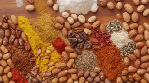 Pulling Back Camera Revealing Nut and Spice Flatlay on Rustic Wood Board for Recipe Video