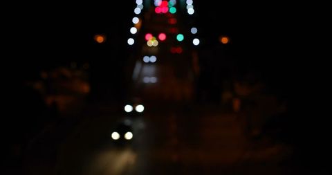 Blurry night traffic lights on city road