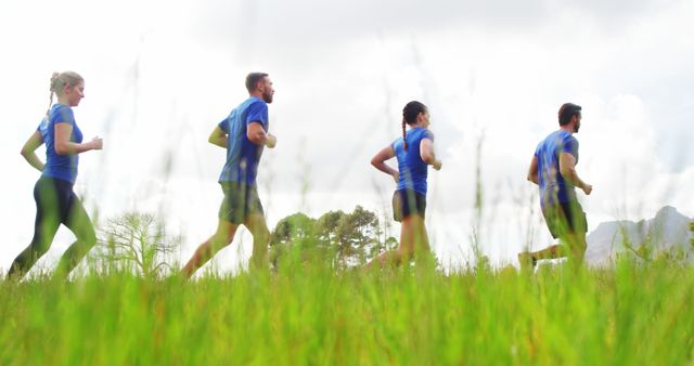 Group Jogging Through Field Promoting Active Lifestyle Outdoors - Download Free Stock Images Pikwizard.com