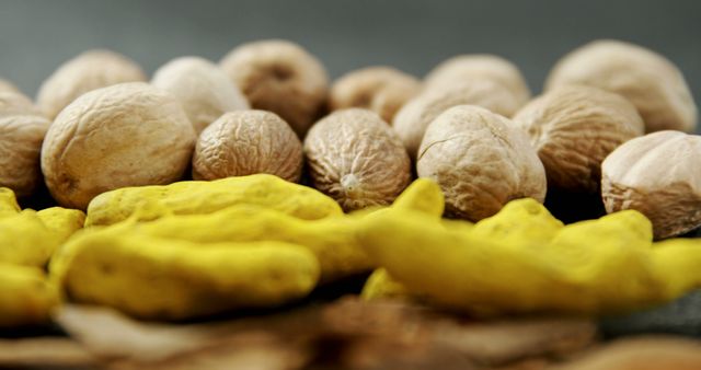 Assorted nuts in shells, including walnuts and peanuts, are displayed prominently against a dark background. Nuts are often recognized for their health benefits, being rich in nutrients and a good source of healthy fats.