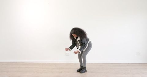 Energetic Dance Expression by African American Woman on Wooden Floor