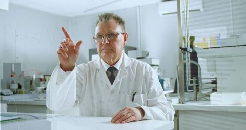 Senior scientist pointing at virtual interface in modern clinical laboratory benchtop research