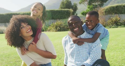 Joyful African American Family Playing in Garden