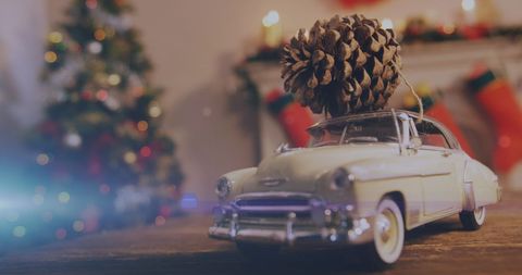 Festive Toy Car with Pine Cone for Christmas Celebration - Download Free Stock Images Pikwizard.com
