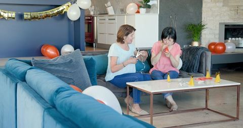 Senior women preparing birthday party at home joyfully
