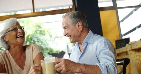 Senior Couple Laughing at Cafe Enjoying Coffee Together - Download Free Stock Images Pikwizard.com