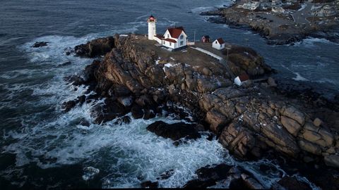 Scenic coastal lighthouse during high tide