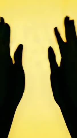 Backlit Shadow Hands Reaching and Clasping on Amber Backlight Vertical 9:16 Video Loop