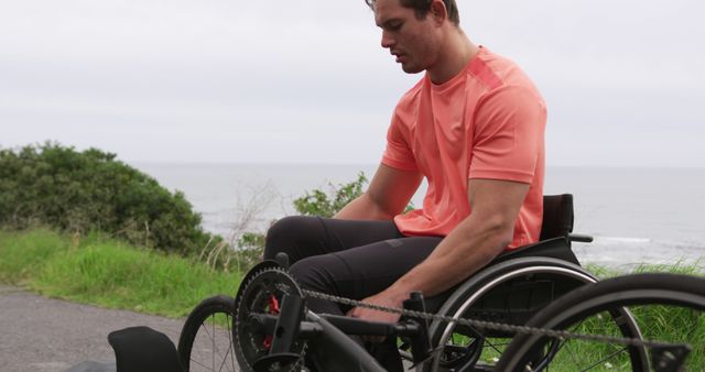 Man in Wheelchair Adjusting Handcycle Outdoors - Download Free Stock Images Pikwizard.com