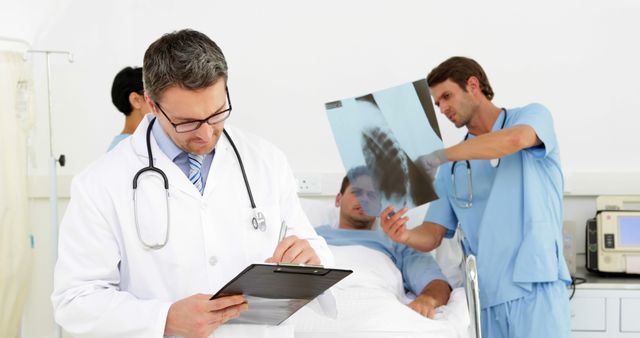 Doctors Examining X-ray Result for Hospitalized Patient's Diagnosis - Download Free Stock Images Pikwizard.com