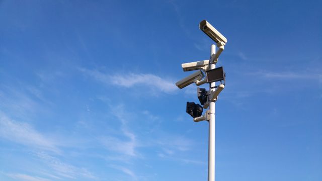 Surveillance Camera System against Clear Blue Sky - Download Free Stock Photos Pikwizard.com