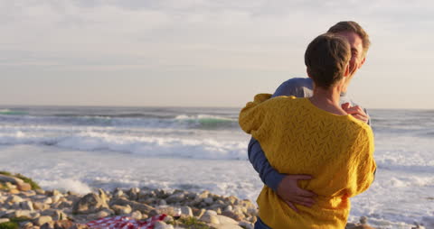 Caucasian Couple Dancing by Beach at Sunset in Slow Motion