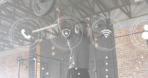 Man pressing loaded barbell overhead inside industrial garage gym with digital ui overlay