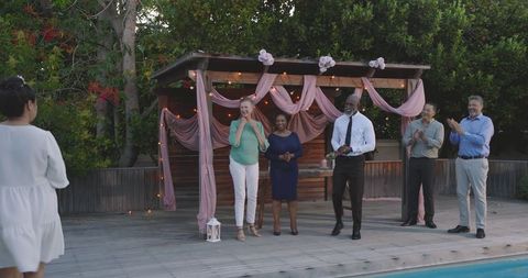 Senior Friends Celebrating Poolside at Wedding Reception