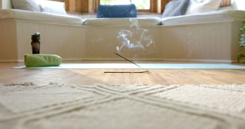 Incense and Yoga Mat in Peaceful Home Setting