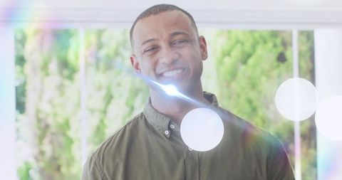 Portrait of smiling man in casual shirt with natural light effects
