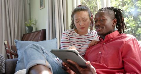 Diverse Couple Relaxing With Tablet in Bright Living Room - Download Free Stock Images Pikwizard.com