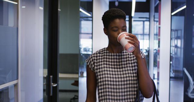 Businesswoman Enjoying Coffee Break in Office Hallway - Download Free Stock Images Pikwizard.com