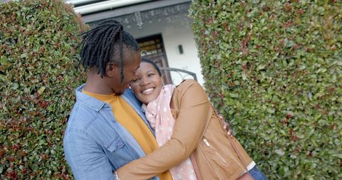 Joyful african american couple embracing outdoors