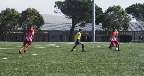 Soccer players competing intently near school field