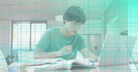 Young man studying at laptop with teal data grid overlay, remote learning concept