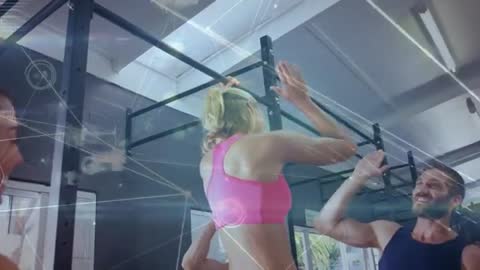 Fitness Enthusiasts Performing Pull-Ups in High-Tech Gym Setting