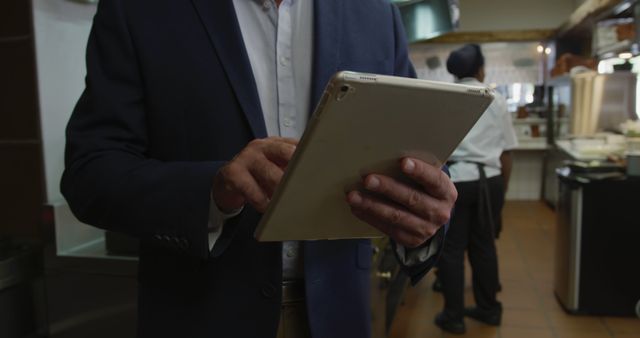 Restaurant Manager Using Tablet in Kitchen - Download Free Stock Images Pikwizard.com