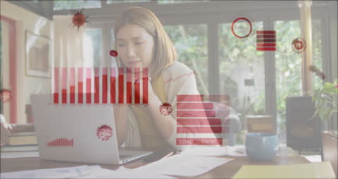 Woman Analyzing Financial Data Amidst Pandemic Concerns at Home