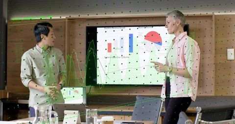 Presenters delivering data-driven presentation with interactive charts and analytics overlays