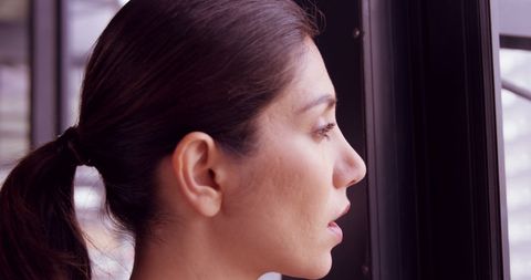 Focused Businesswoman Gazing Out Office Window