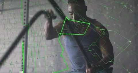 Athlete engaged in battle rope workout with tech overlay