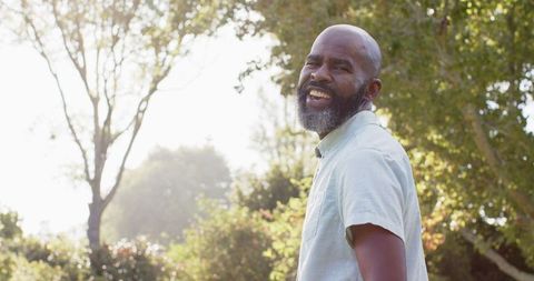 Smiling Mature Man Enjoying a Sunny Day in Park