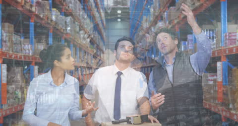 Team Discussing Logistics in Warehouse with Financial Data Overlay