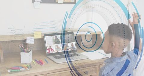 Child raising hand for online class at home desk with laptop, markers and HUD